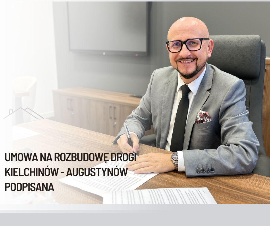 w&oacute;jt gminy bełchat&oacute;w konrad koc siedzi przy biurku i&nbsp;pdpisuje umowę