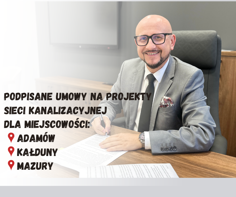 w&oacute;jt konrad koc siedzi przy bourku i&nbsp;podpisuje umowę