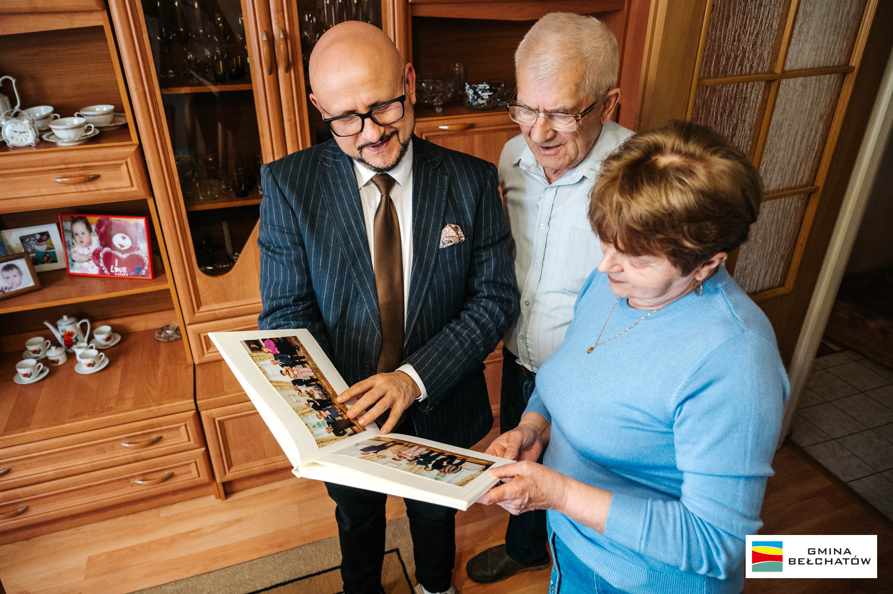 w&oacute;jt konrad koc ogląda album ze zdjęciami razem z&nbsp;kobietą i&nbsp;mężczyzną w&nbsp;podeszłym wieku